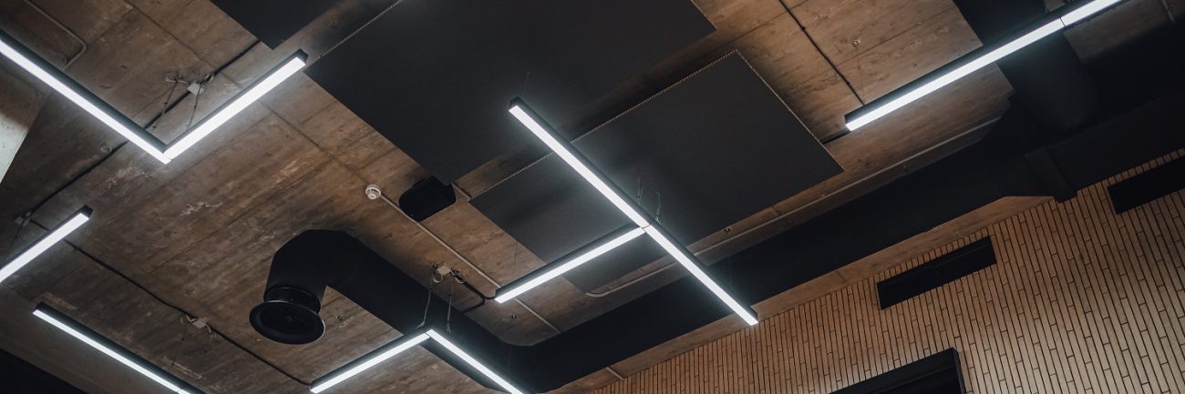 View on modern led lighting hanging from ceilings, industrial building concrete texture
